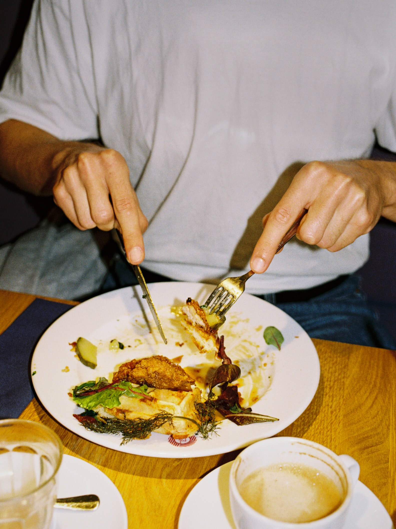 Close-up shot of someone enjoying a meal at Frühstück 3000, captured on Canon EOS 300 35mm film.