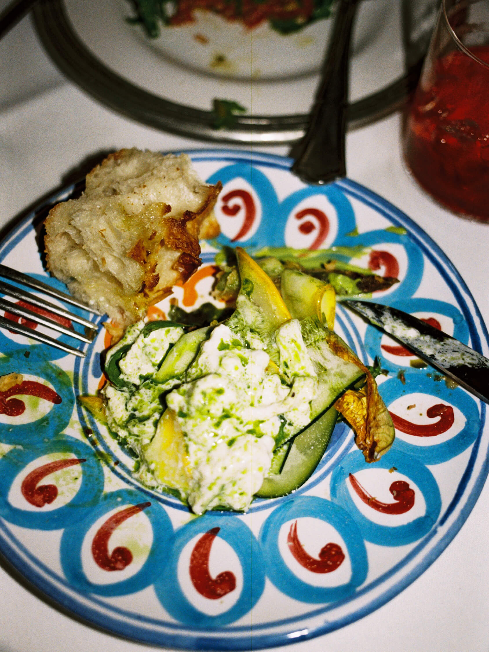 Starter plate of grilled squash and fresh cream served on a blue patterned ceramic plate at Pamela Berlin.